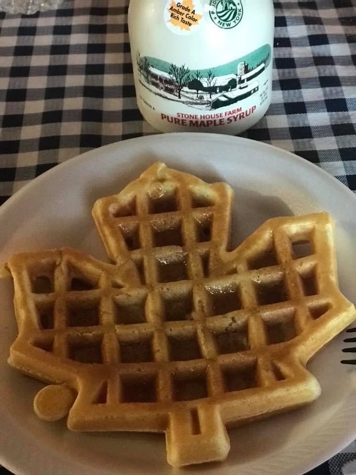 maple leaf shaped waffle with maple syrup